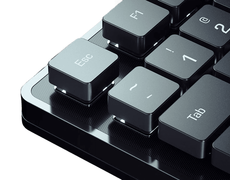 Close-up of the KEYSTROKE K/74 aluminium keyboard, light catching the edge of its machined case and PBT keycaps